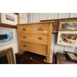 An Edwardian satin walnut three drawer chest