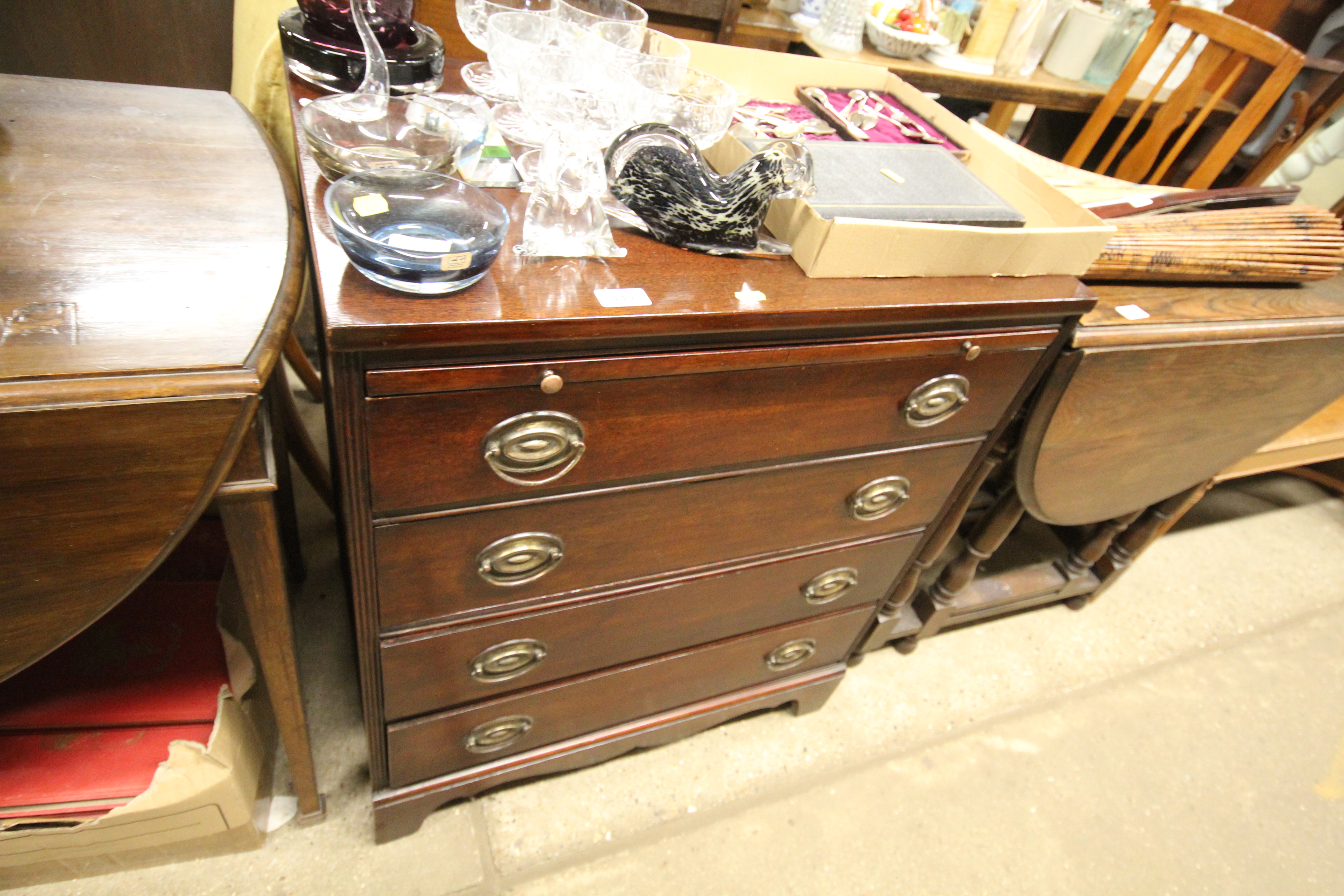 A mahogany four drawer chest fitted with a brushin