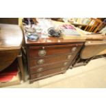 A mahogany four drawer chest fitted with a brushin