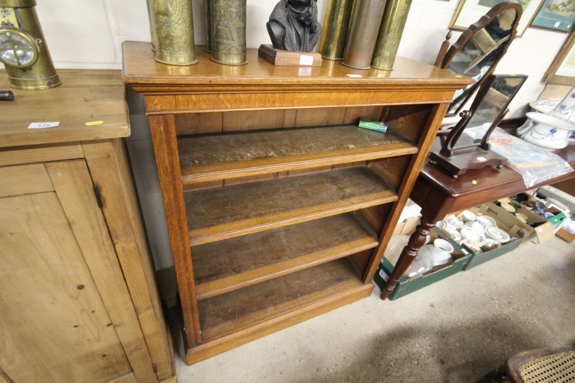 A late Victorian golden oak open fronted bookcase