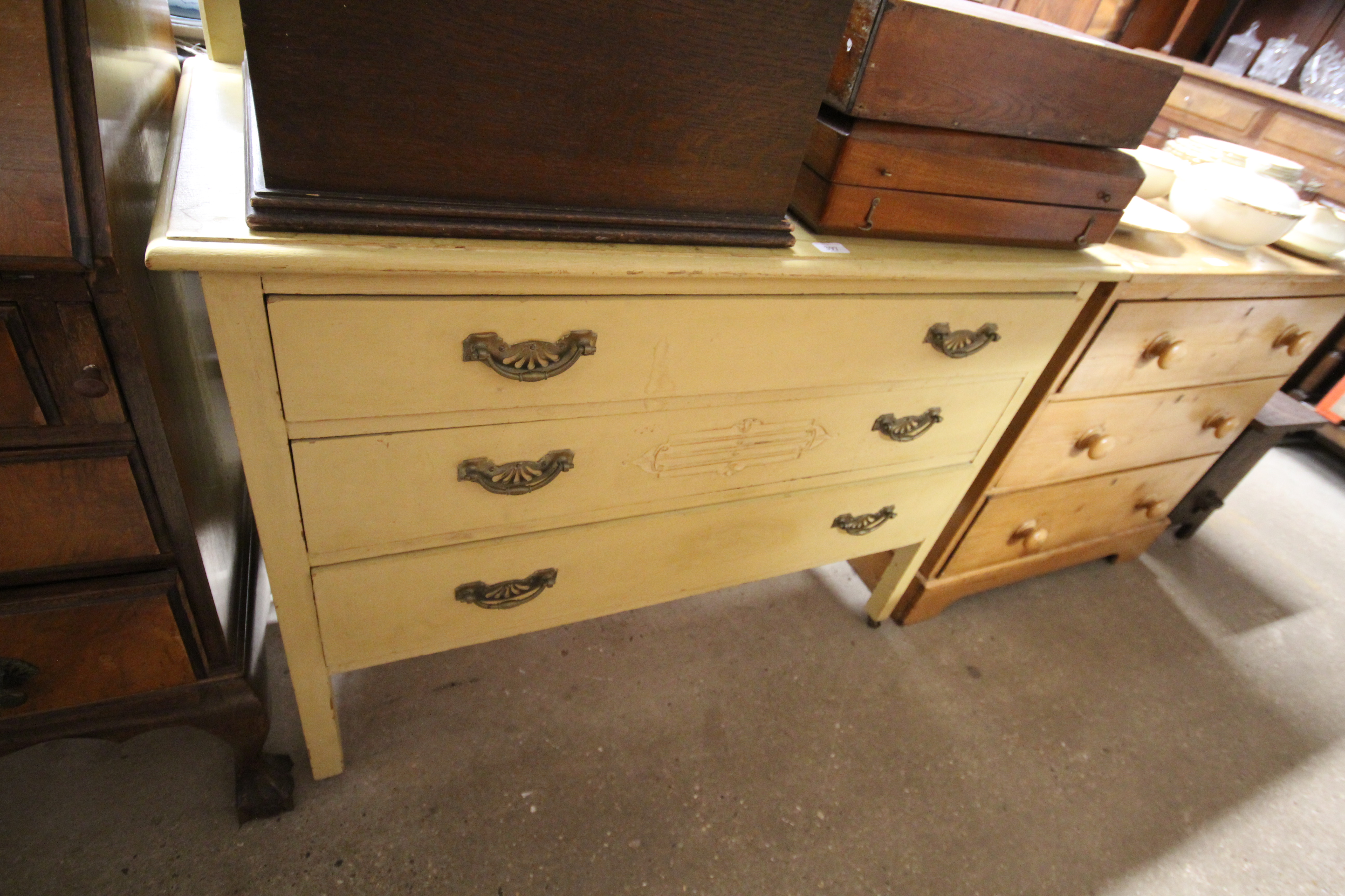 A yellow painted three drawer chest