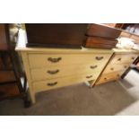 A yellow painted three drawer chest