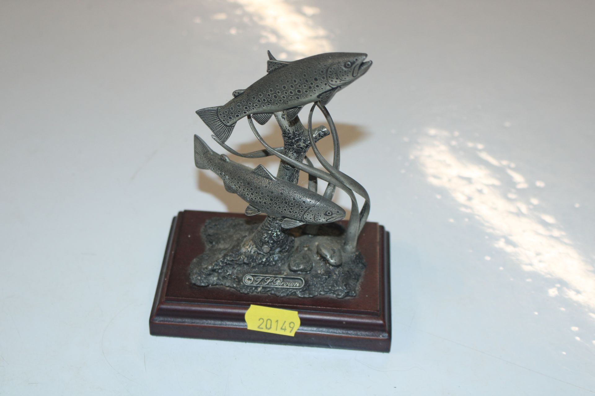 A sculpture depicting salmon, signed T.P. Brown