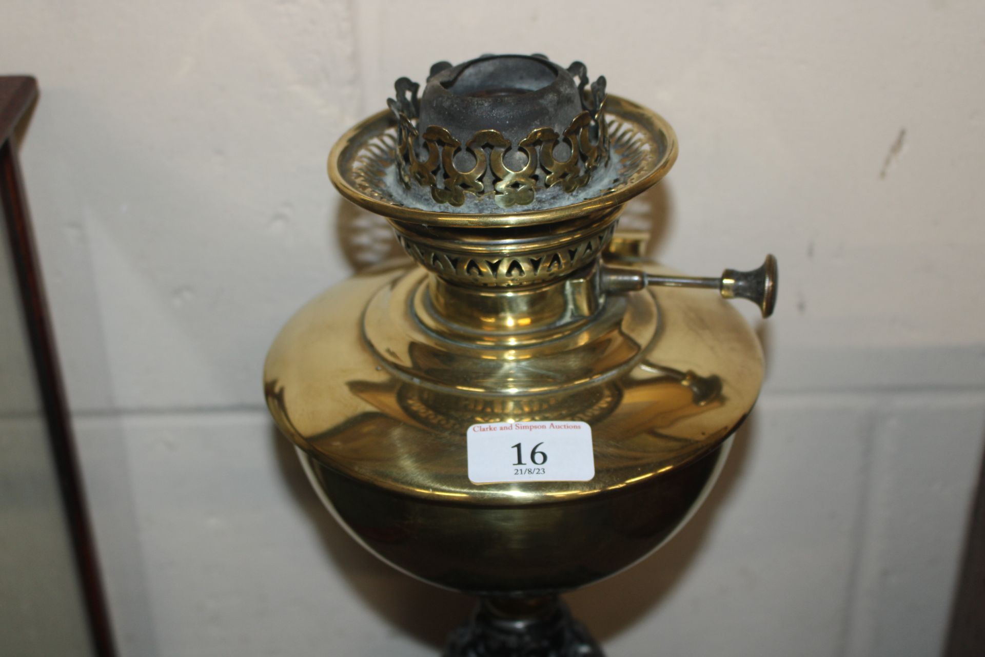 A brass and cast iron oil lamp with blue tinted sh - Image 4 of 4