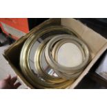 A box of various brass mirrors