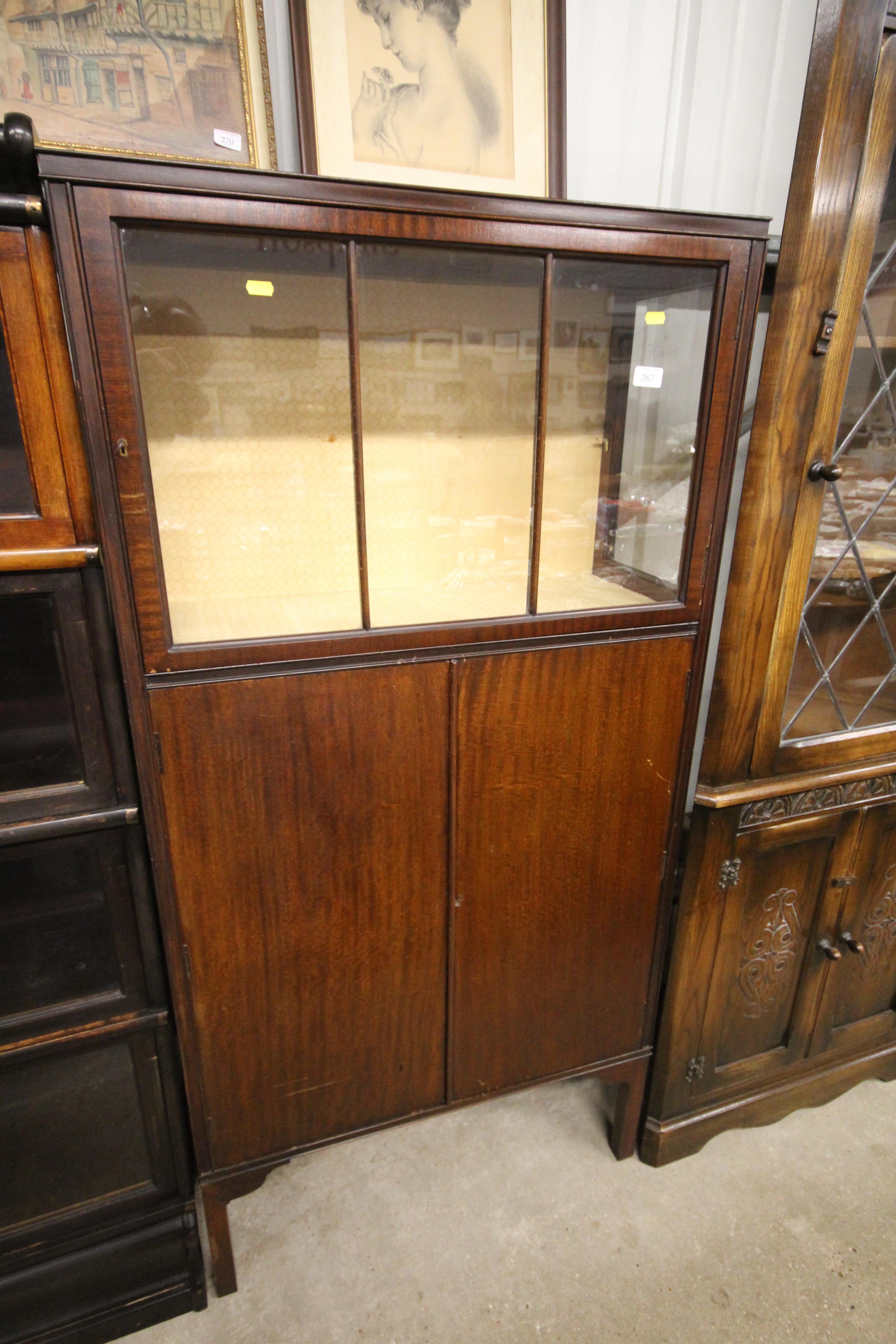 A 20th Century mahogany display cabinet with cupbo