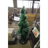 An artificial Christmas tree with plastic stand