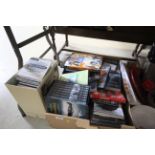 A box of various DVDs and CDs