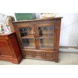 An oak and leaded glazed side cabinet