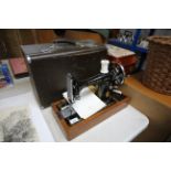 A Singer hand sewing machine with carry case