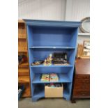 A blue painted open fronted bookcase