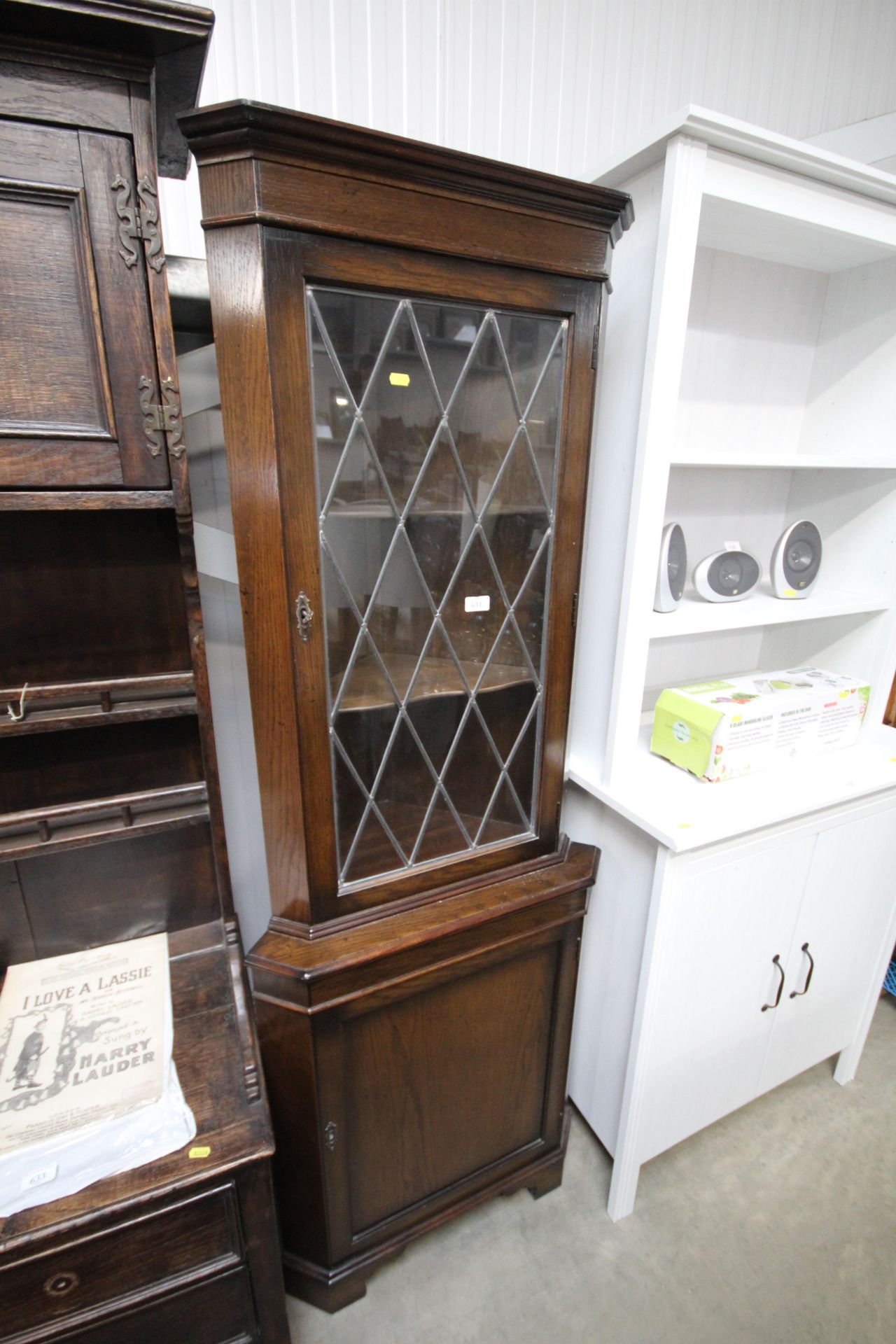 An oak and leaded glazed corner cabinet