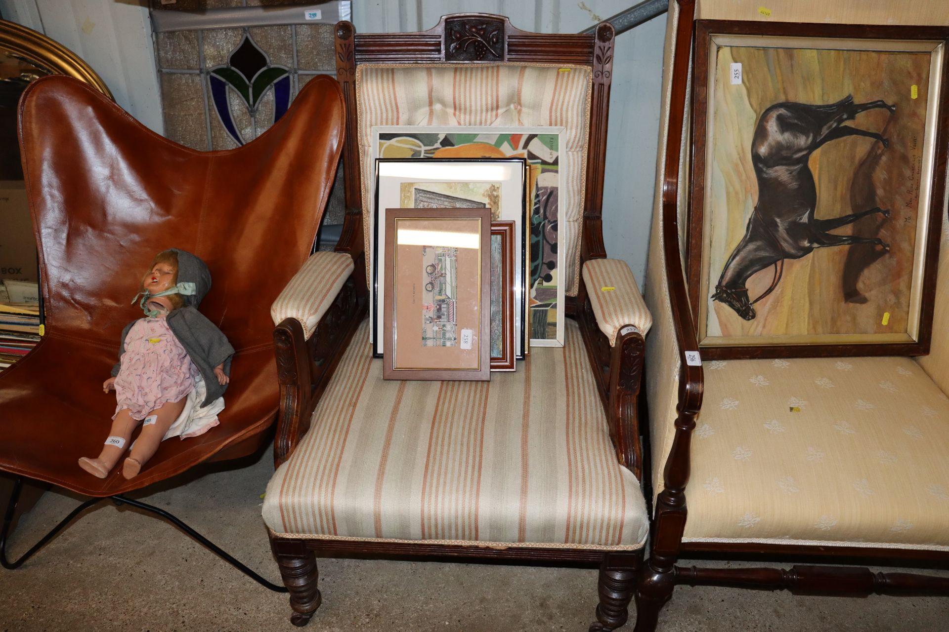 An Edwardian walnut framed upholstered armchair