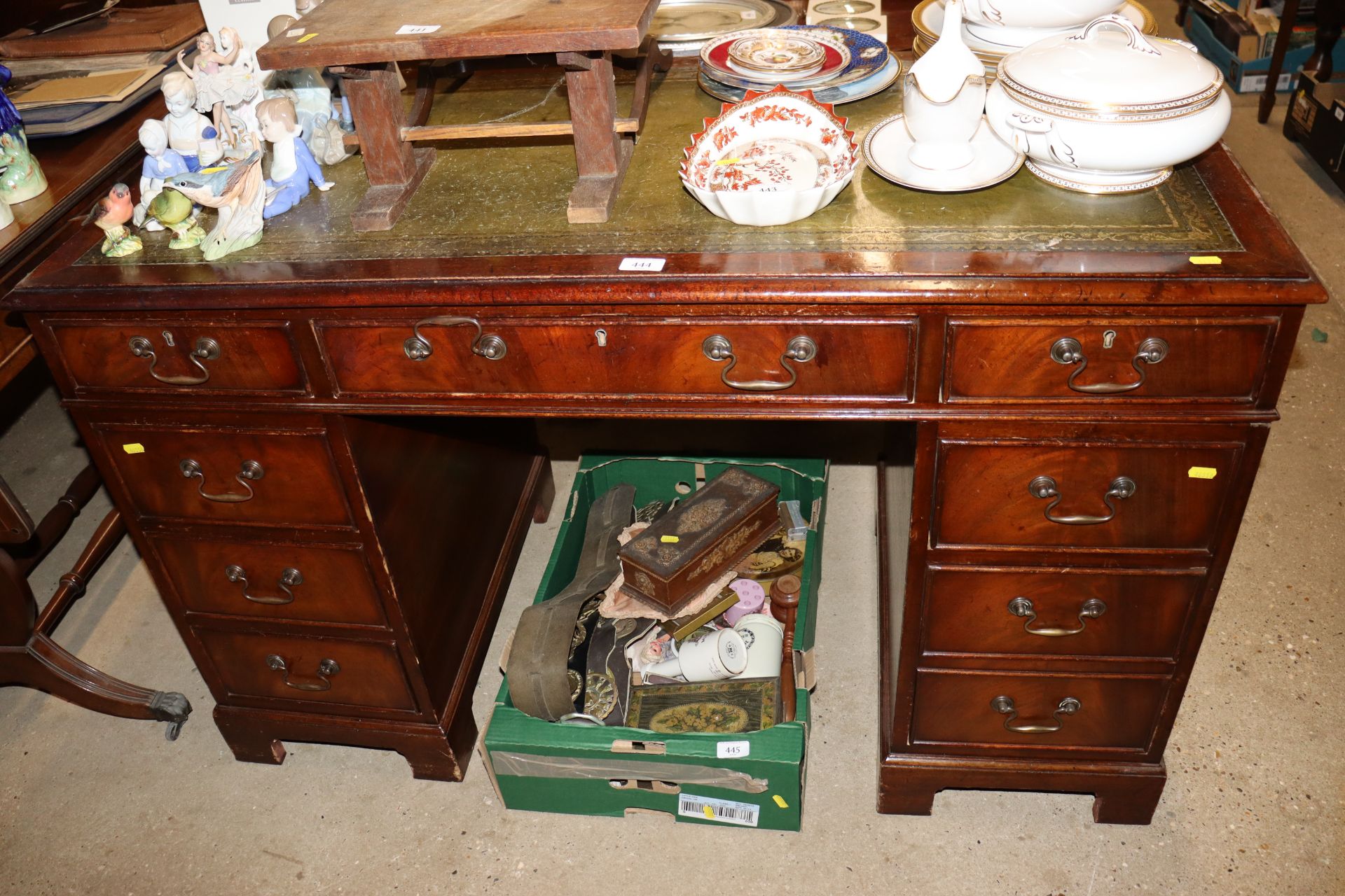 A mahogany pedestal writing desk with green leathe