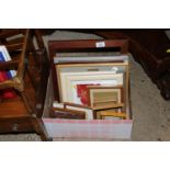 A box of various prints and frames