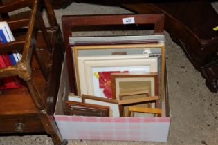 A box of various prints and frames