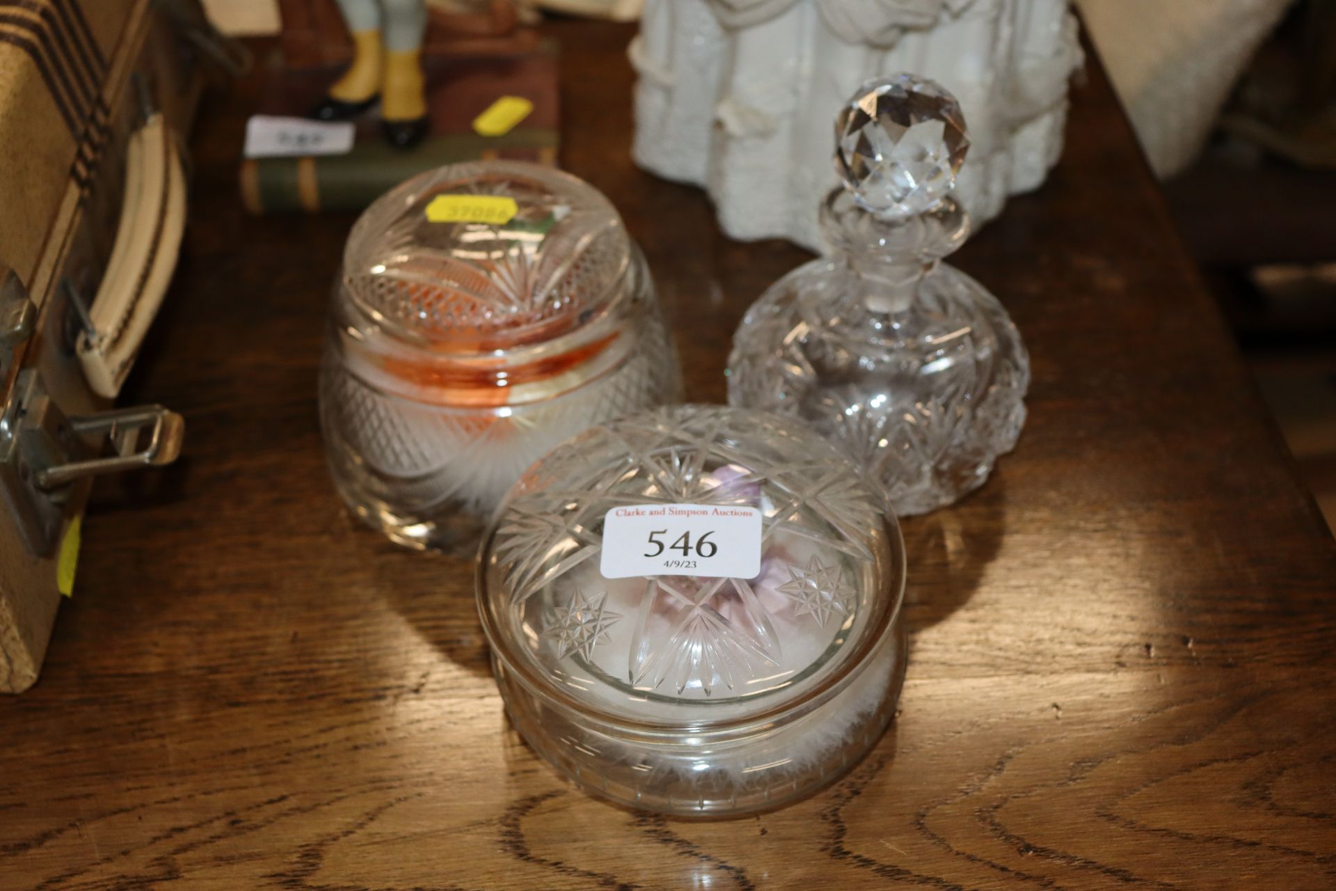 Two powder puff jars and a cur glass scent bottle