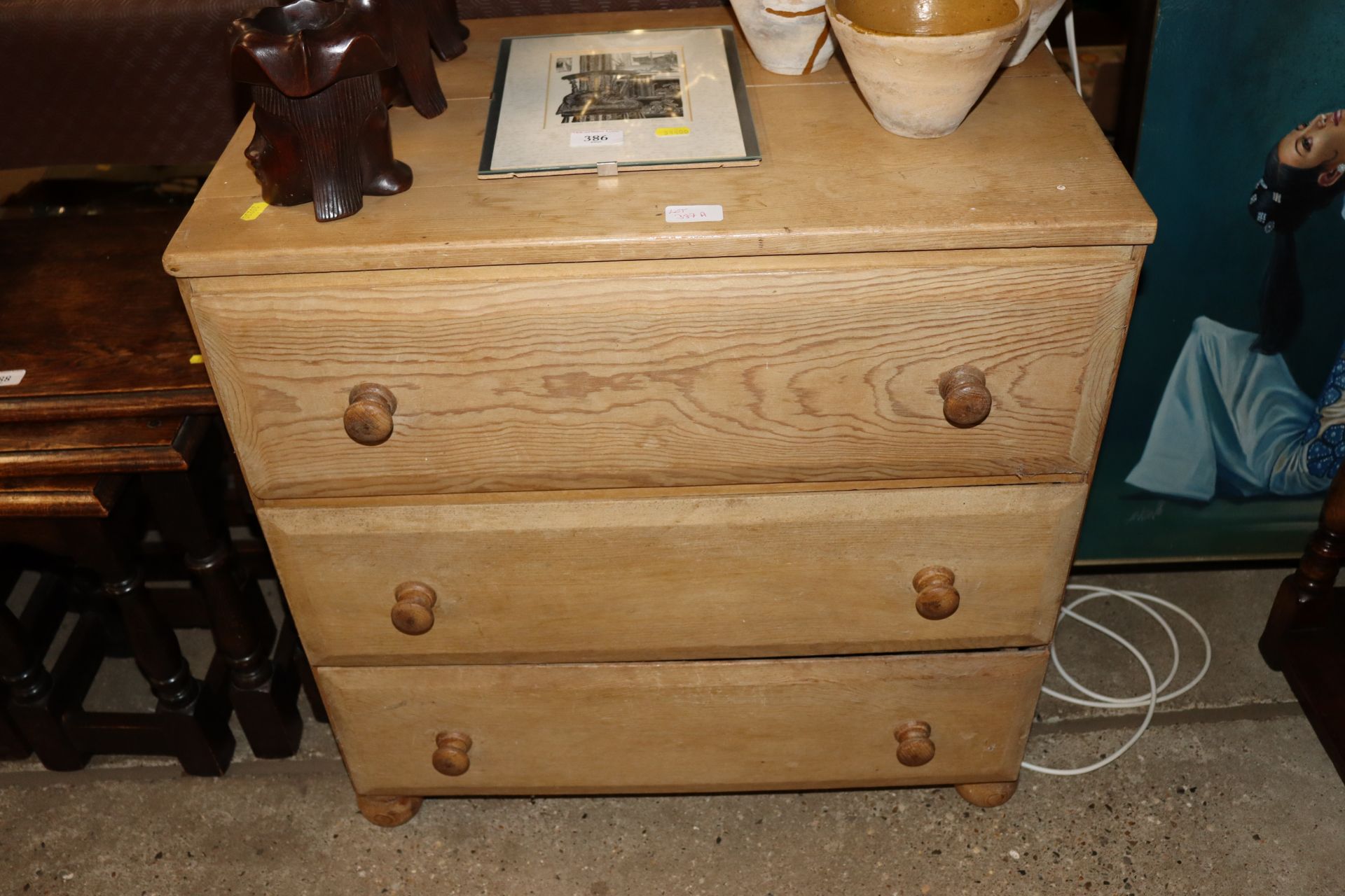 A pine three drawer chest