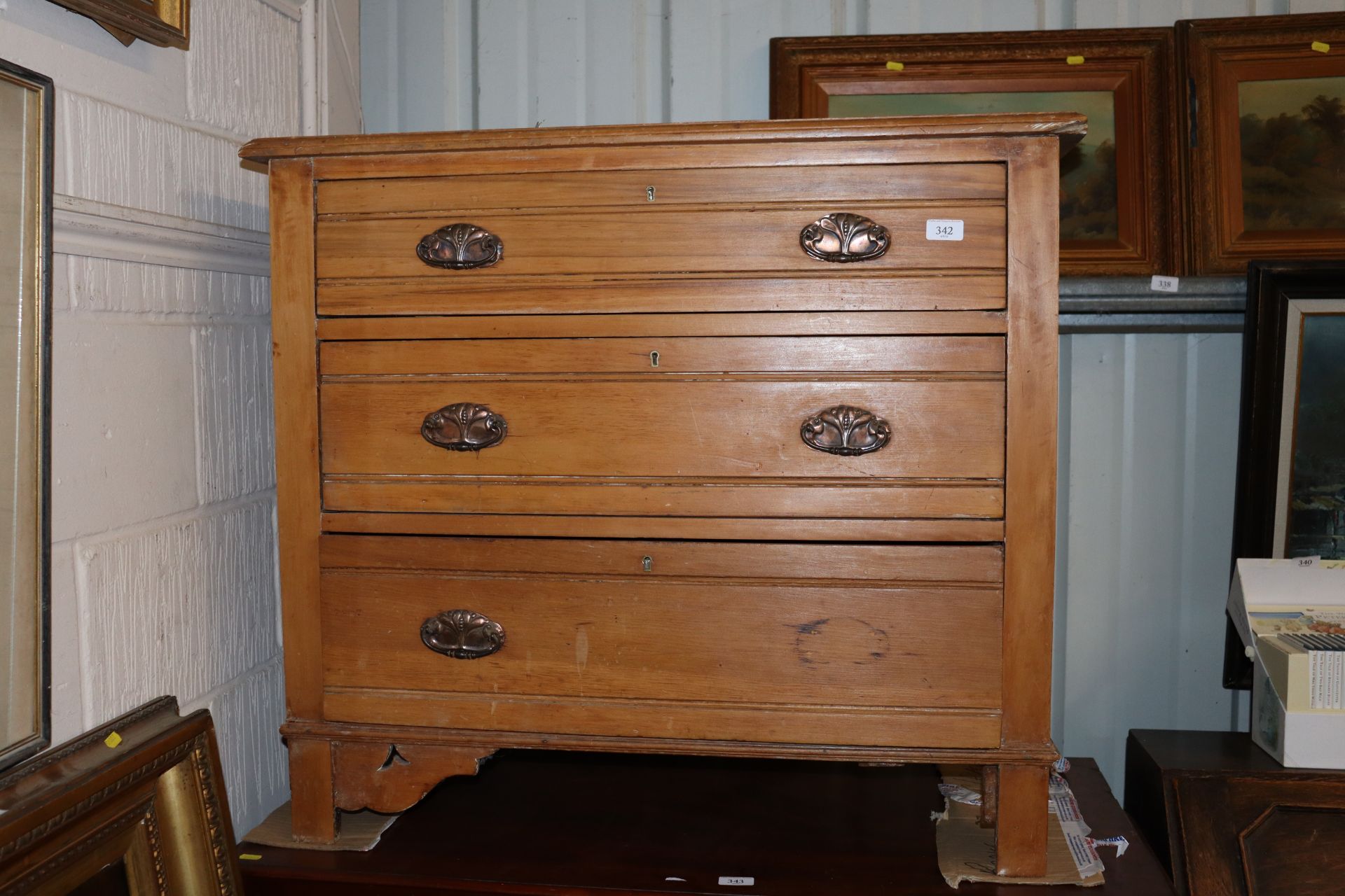 An Edwardian satin walnut chest of three drawers