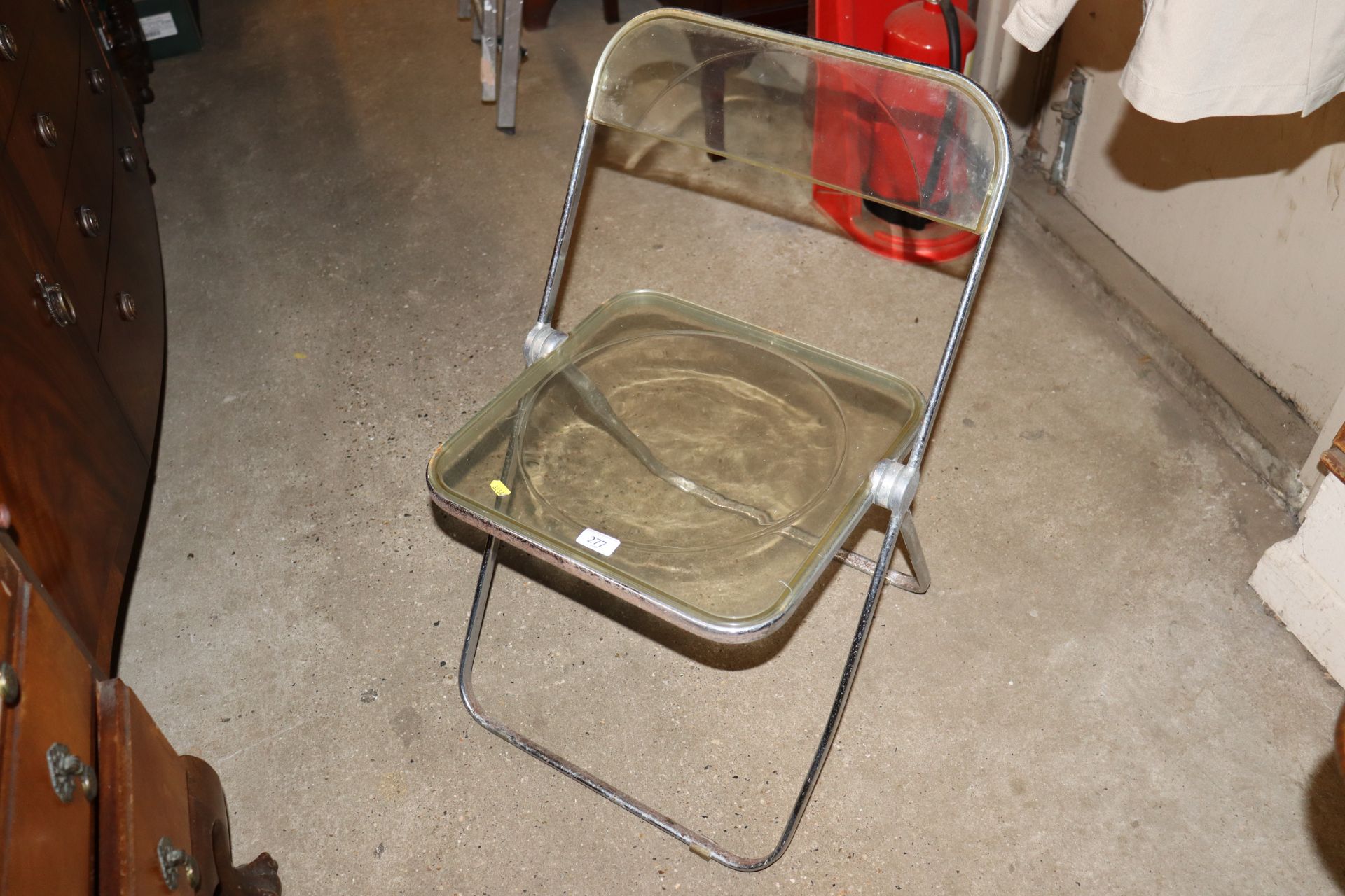 A Castelli folding metal and Perspex chair