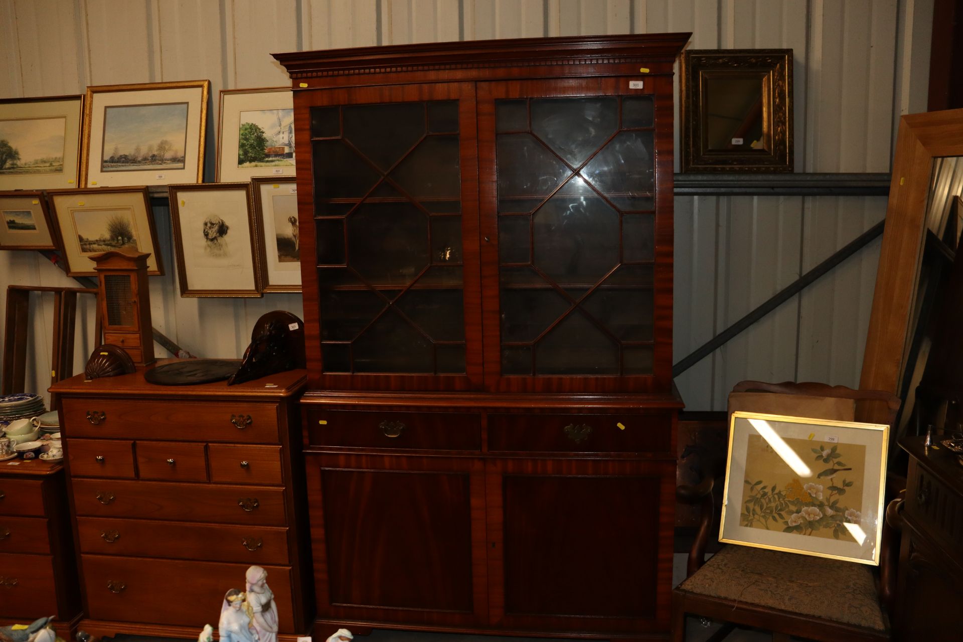A reproduction mahogany bookcase on cabinet