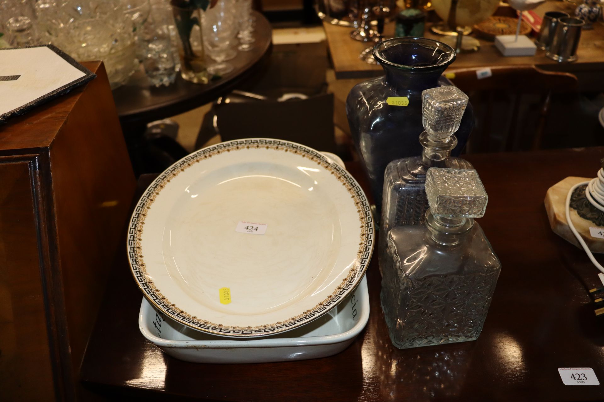 Two glass decanters; a blue glass vase; an Emma Br