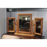 A stripped pine triple dressing table mirror