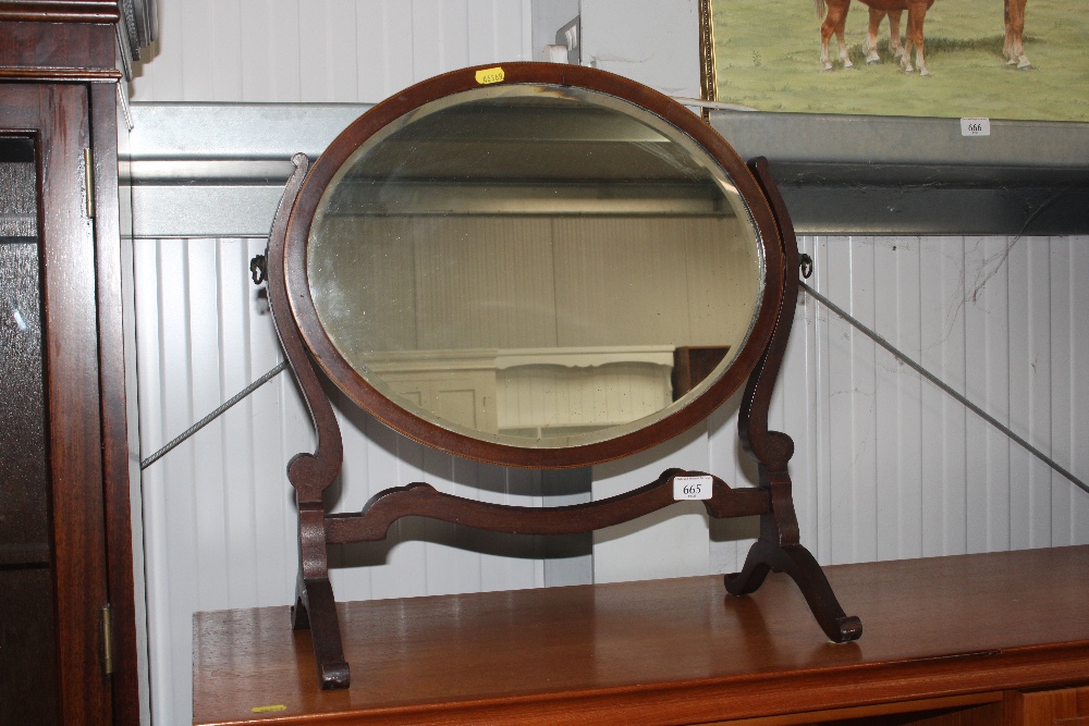 A 19th Century mahogany oval swing toilet mirror