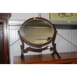 A 19th Century mahogany oval swing toilet mirror