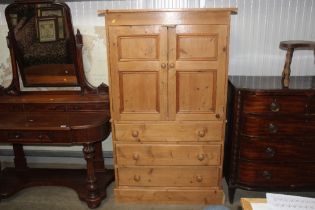 A stripped pine press cupboard