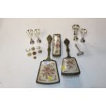 Four silver beakers; a silver child's pusher and a part dressing table set