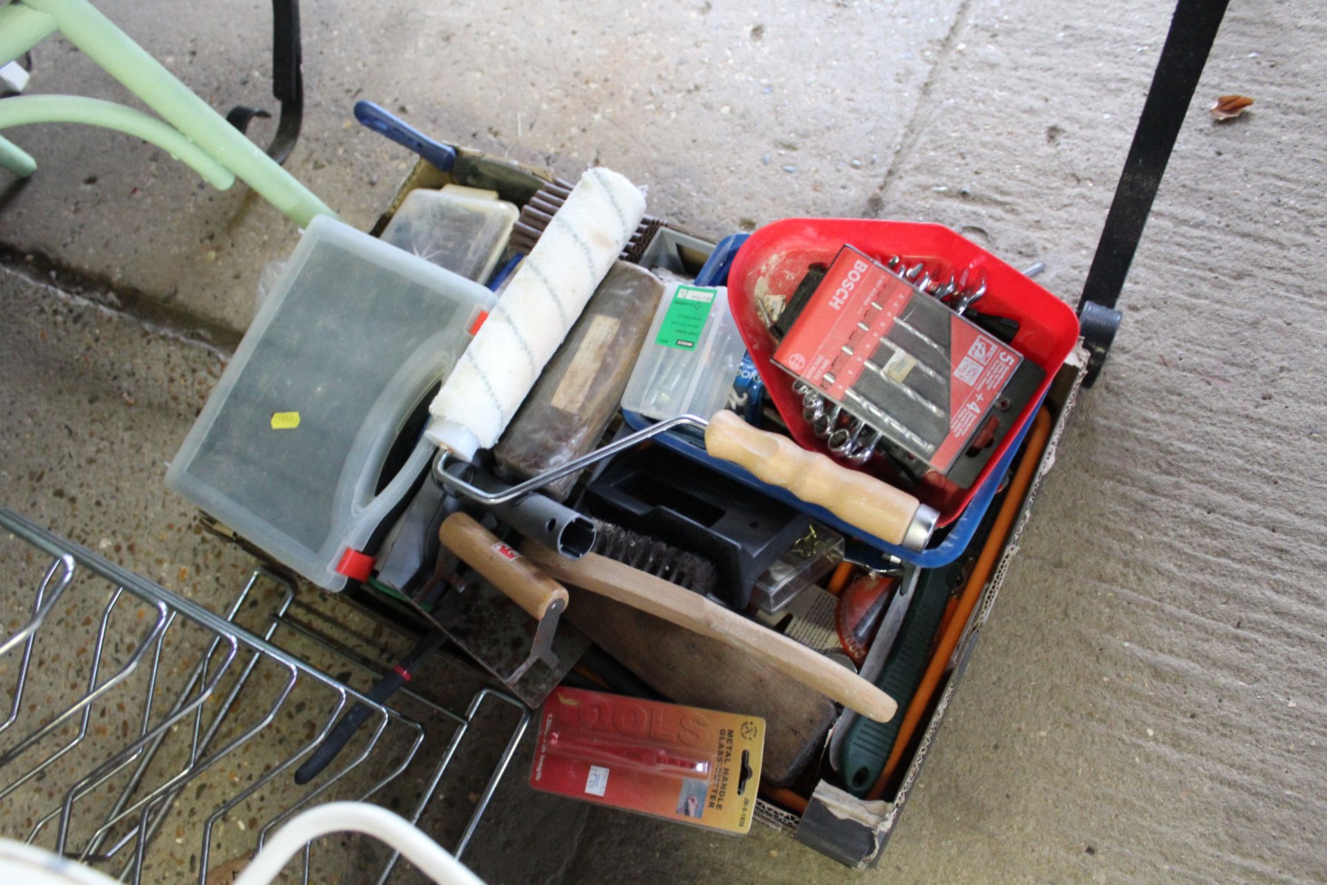 A box containing various tools to include paint ro