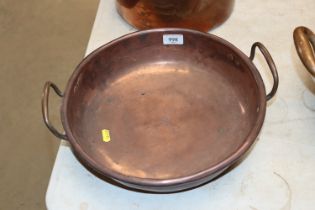 A copper twin handled pan approx. 13" diameter