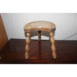 A rustic elm three legged stool