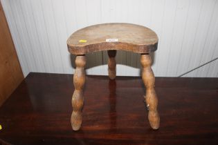 A rustic elm three legged stool