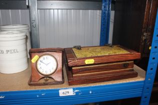A cross eight day traveling alarm clock and a small pine map decorated trinket box