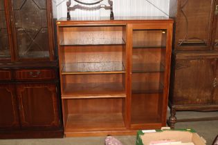 A teak display cabinet