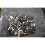 A box of miscellaneous plated flatware and cutlery