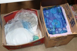 Two boxes of material and table linen