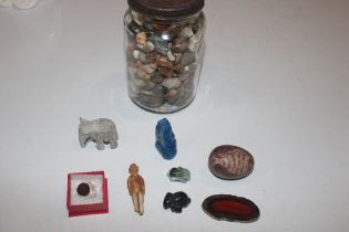 A glass jar and contents of various polished stone