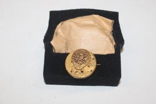 A watch movement converted to a brooch and a colle