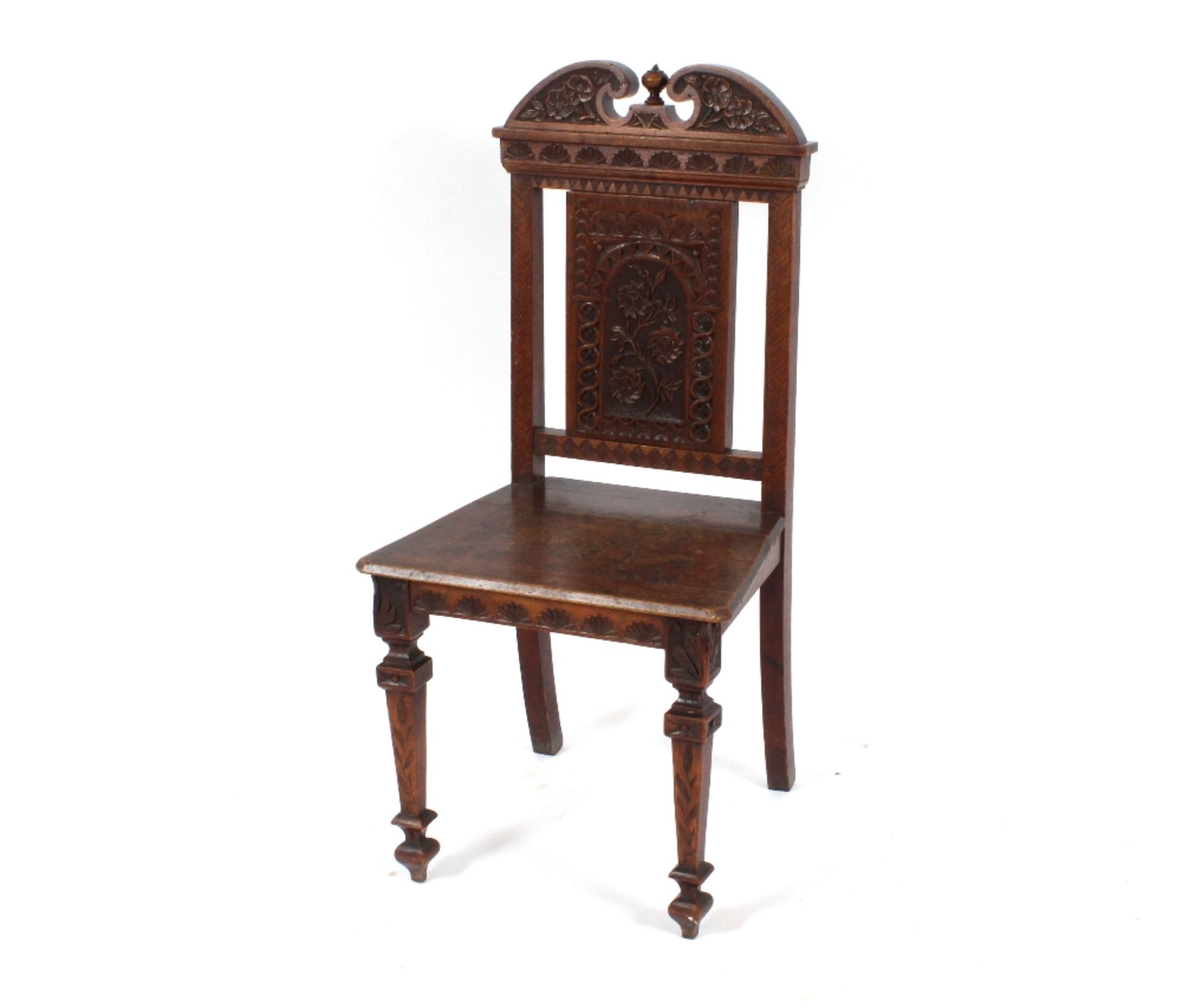 A pair of early 20th Century carved oak hall chair