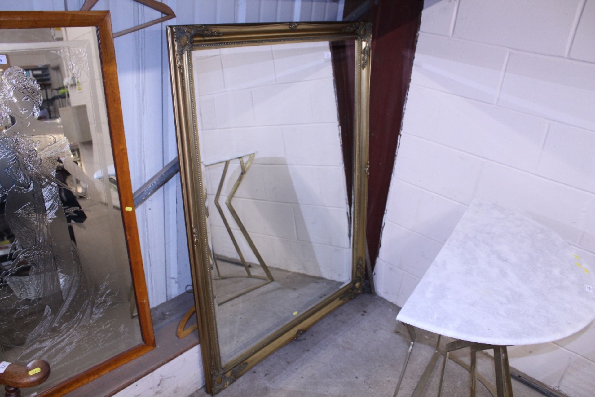 A large gilt framed bevel edged wall mirror