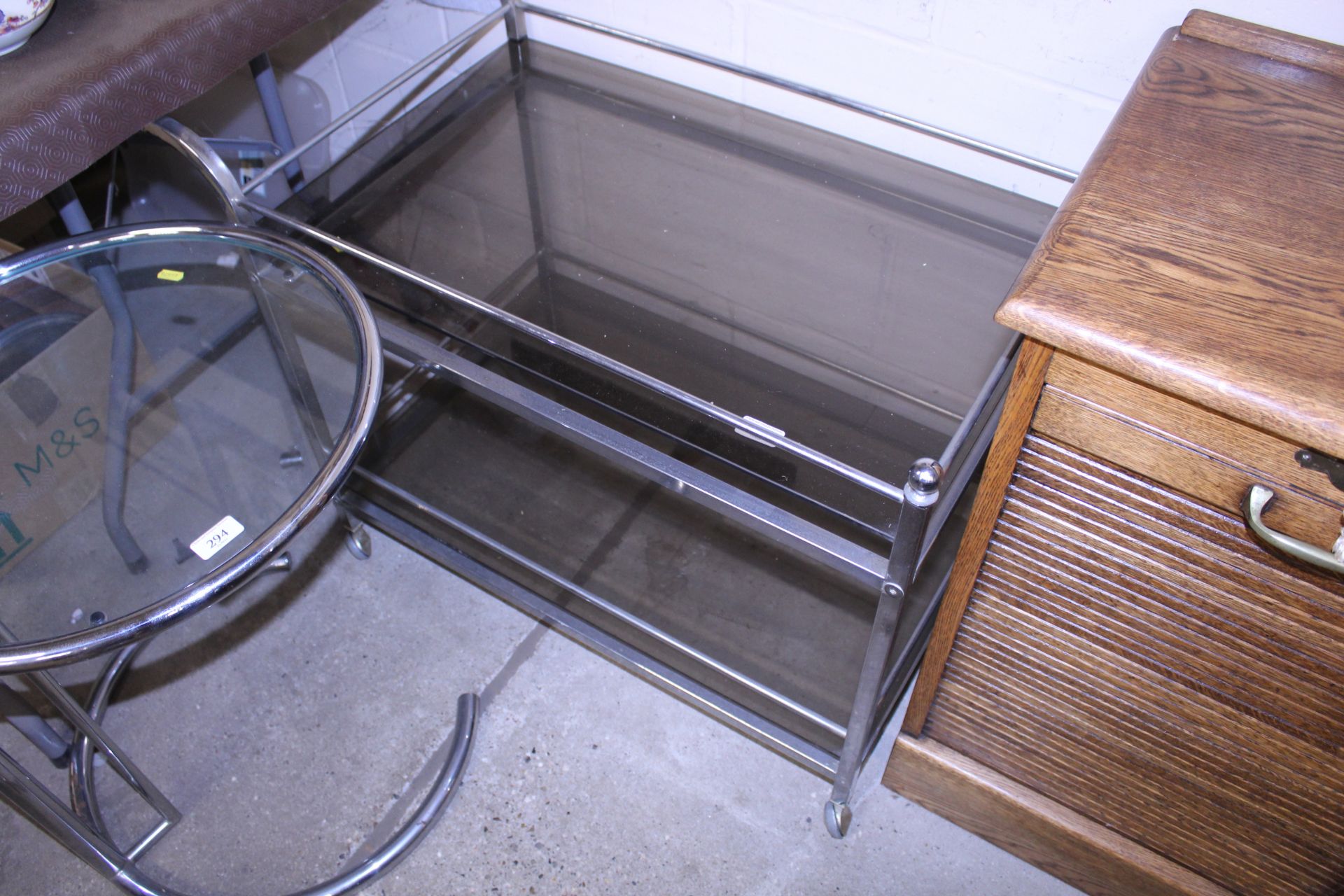 A retro style chrome and smoked glass tea trolley