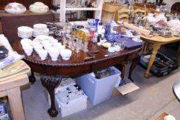 A mahogany extending dining table with carved deco