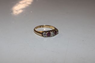 An 18ct gold ring set with three diamonds and colo