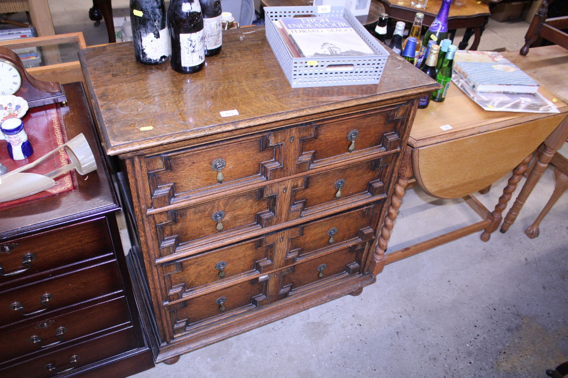 An oak chest of four drawers in the Jacobean style