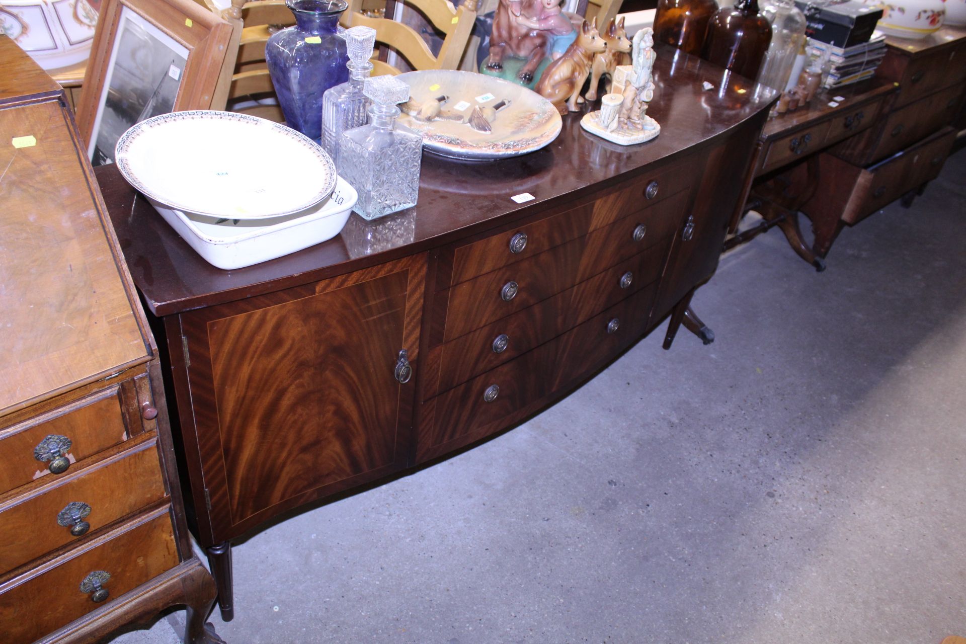 A reproduction mahogany bow fronted sideboard