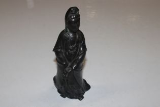 An Oriental bronze figure, 23cm high