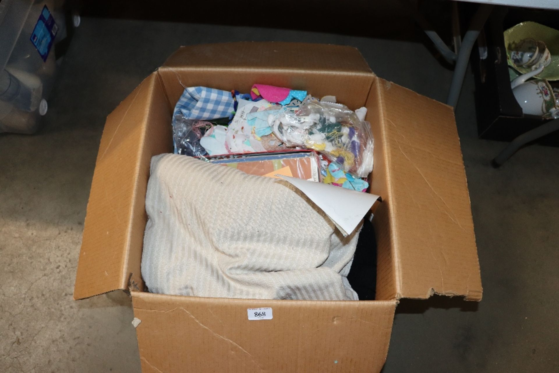 A box containing various material, wool, sewing it